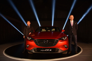 BEIJING, CHINA - APRIL 24: Iwao Koizumi, Chief Designer for CX-4 （L） and Naoki Okano, Program Manager for CX-4 of Mazda Motor Co （R） pose for photographs during the Pre-Event For Beijing Motor Show - Auto China on April 24, 2016 in Beijing, China. Mazda China unveiled the CX-4, a brand new SUV model in the event. （Photo by Xiaolu Chu/Getty Images for Mazda Motor Co ） *** Local Caption *** Naoki Okano; Iwao Koizumi